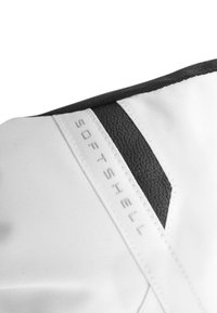White softshell fabric with a textured black accent panel. Features the word "SOFTSHELL" in gray, blending with the sleek design.