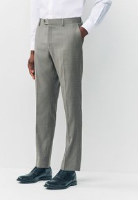 Gray dress pants in lightweight fabric with a subtle check pattern, tailored fit, and side pockets, paired with black leather shoes.