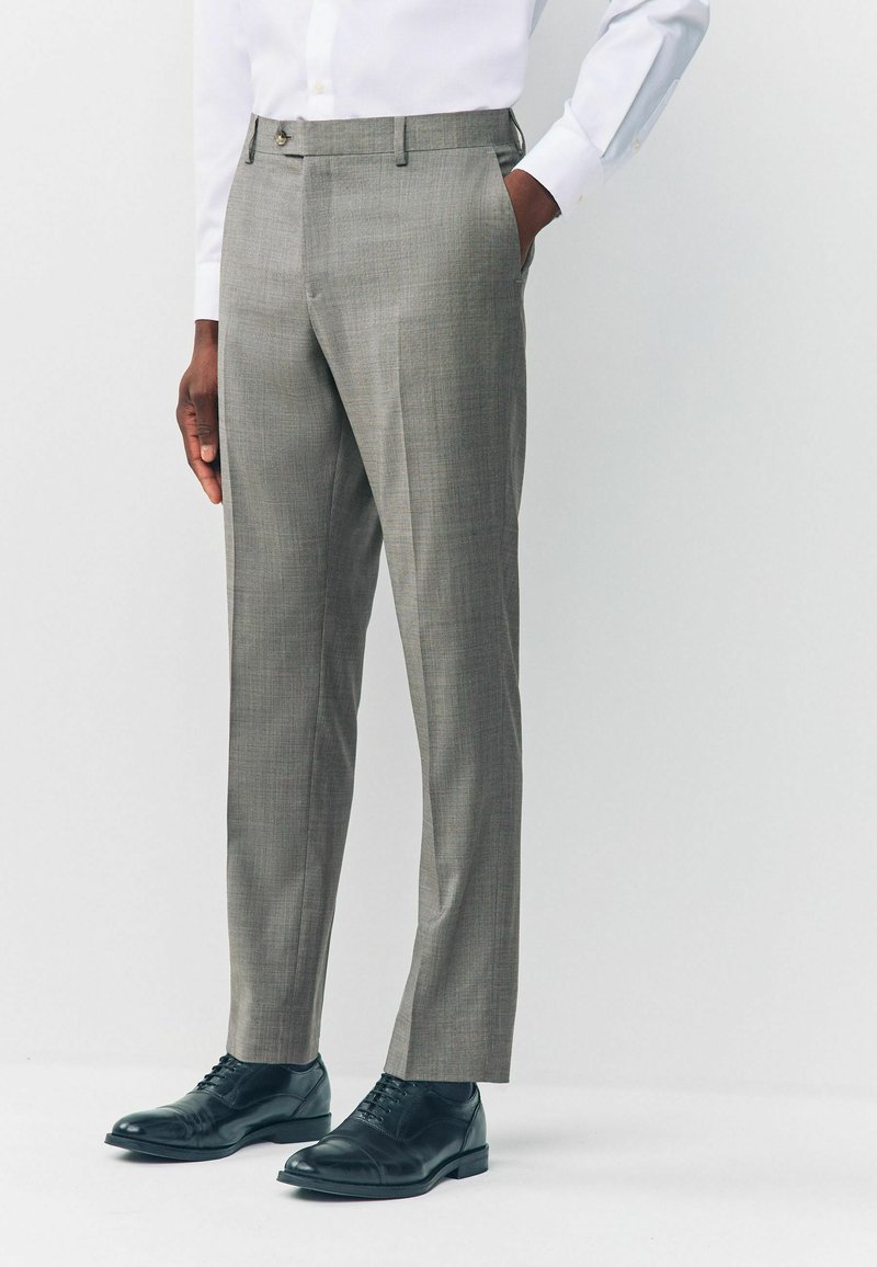 Gray dress pants in lightweight fabric with a subtle check pattern, tailored fit, and side pockets, paired with black leather shoes.
