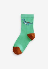 Calzino di cotone verde con un design di dinosauro, caratterizzato da accenti blu e rossi, tacco e punta marroni, e polsino a costine.