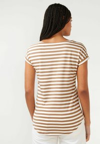 Brun och vit randig T-shirt med korta ärmar, rund halsringning och en lätt krökt nederkant, tillverkad av ett mjukt och lätt tyg.