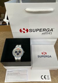 Silver watch with blue accents and three sub-dials in a black box. Brand packaging features red logo on white bag and box.