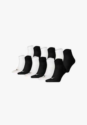 Pack of 12 ankle socks: 6 black and 6 white. Each sock features a ribbed cuff and a small logo on the side. Made of soft cotton blend.