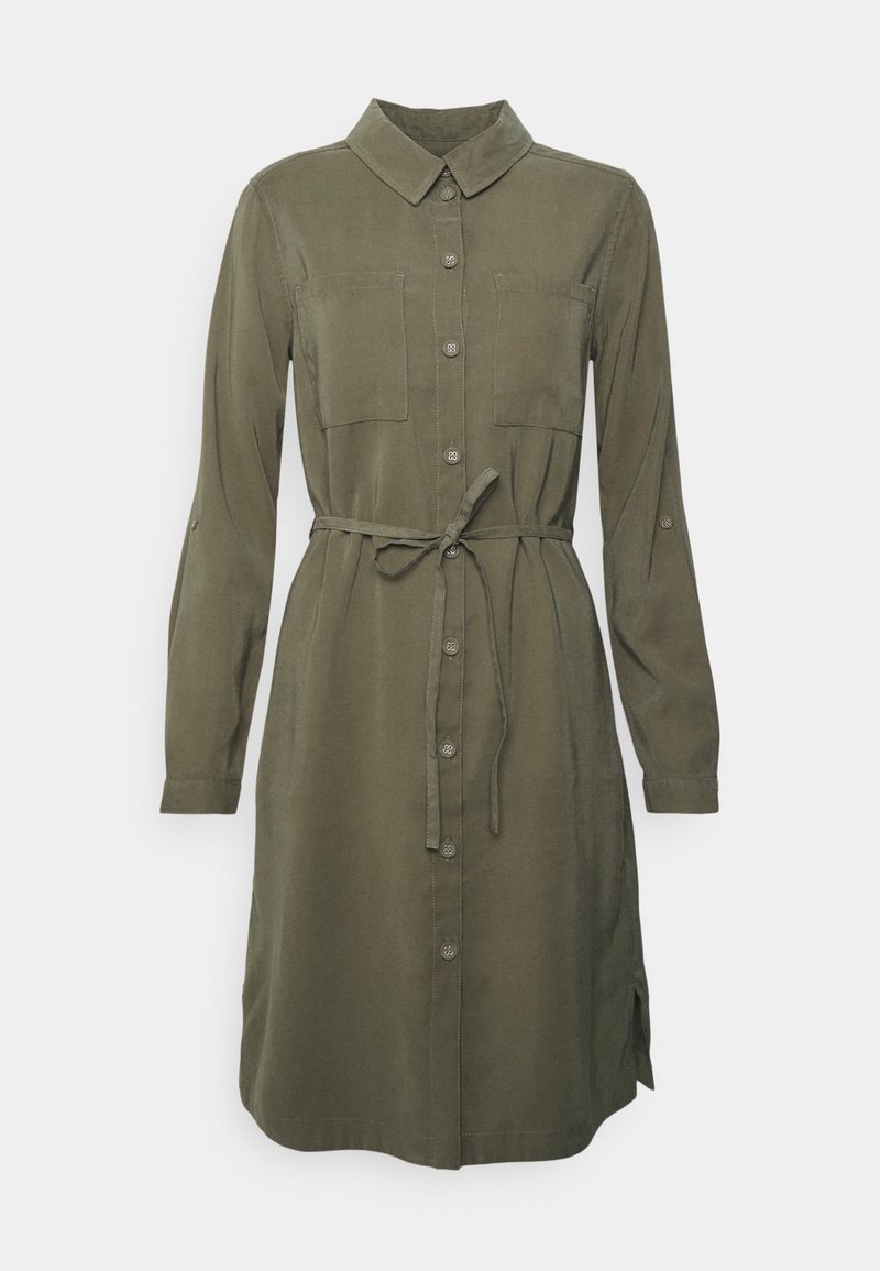 Olive green shirt dress with long sleeves, collar, double chest pockets, button front closure, and a tied belt at the waist. Side slits included.
