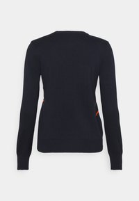 Navy blue knit sweater with long sleeves, round neckline, and ribbed cuffs; features subtle orange accent on the side. Soft texture.