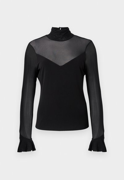 Fekete hosszú ujjú felső magas gallérral. Áttetsző anyaggal a vállakon és V-alakú kivágással a mellkasnál. Harang alakú ujjvégek a mandzsettánál.