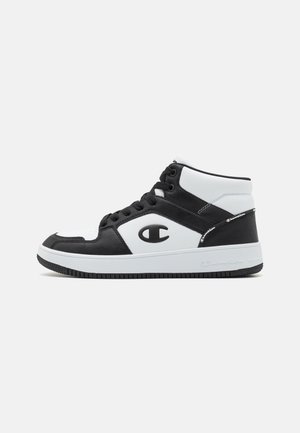 High-Top-Sneaker mit einem Schwarz-Weiß-Farbschema, aus Leder und Mesh-Materialien, mit Logo-Akzenten und strukturiertem Gummisohle.