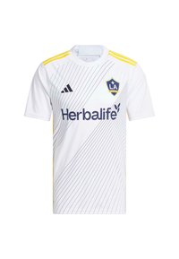 Vit fotbollströja med gula accenter, prydd med diagonala blå ränder, "Herbalife"-logotyp och "LA Galaxy"-sköld på bröstet.