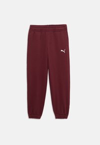 Pantaloni sportivi bordeaux con vita elasticizzata, polsini affusolati e un piccolo logo bianco sul lato sinistro. Tessuto morbido.
