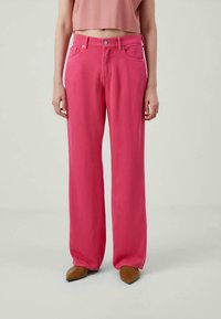 Roze wijde jeans met een gladde textuur, vijf-pocket ontwerp, metalen knoopsluiting en subtiele stiksels. Gecombineerd met een cropped top.