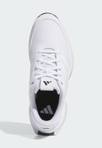 White athletic shoe with a textured mesh upper, flat laces, and a logo patch. Features a cushioned sole and contrasting black insole.