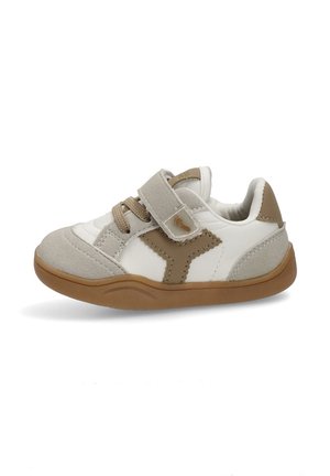 Zapatilla blanca y marrón con una tira de velcro, parte superior de ante y sintético, cuello acolchado y suela de goma. Diseño simple, punta redondeada.