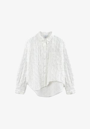 Camicia bianca con bottoni, realizzata in tessuto testurizzato, dotata di colletto aperto, maniche lunghe e orlo curvo. Include una tasca a toppa.