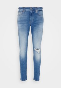 Jeans de mezclilla azul ajustados con un acabado desgastado y detalle de rasgado en la rodilla. Cuenta con bolsillos estándar y herrajes metálicos.