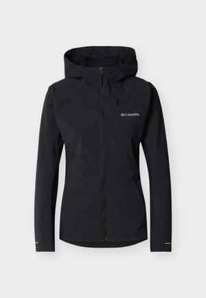 Μαύρο καπιτονέ μπουφάν Columbia με κουκούλα, μαλακό υλικό τύπου softshell, πλήρης φερμουάρ μπροστά και λογότυπο στο στήθος, σχεδιασμένο για υπαίθρια χρήση.