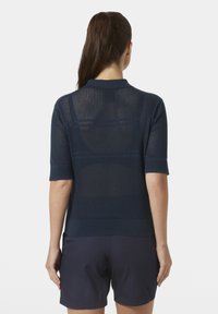 Námořnická tričko s krátkým rukávem z pleteniny s texturovaným, otevřeným vzorem. Obsahuje límec a žebrované manžety, navrženo pro prodyšný střih.