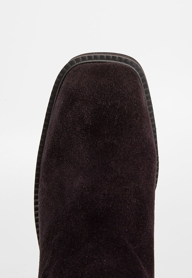 Czarne zamszowe botki za kostkę z okrągłym noskiem, gumową podeszwą i teksturowanym wykończeniem krawędzi. Gładka powierzchnia, bez widocznych wzorów czy elementów metalowych.