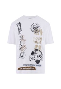 Vit bomulls-T-shirt med olika tryckta grafiker, inklusive text och stämplar i svart och brunt. Rundad hals och design med korta ärmar.