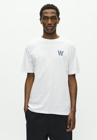 White cotton t-shirt with a round neckline, short sleeves, and a blue logo on the left chest. Simple, classic cut with a smooth texture.