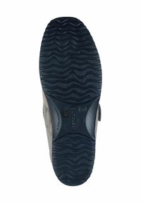 Black rubber sole with textured wavy pattern. Light gray suede upper with a curved design and Velcro strap on the side for adjustment.