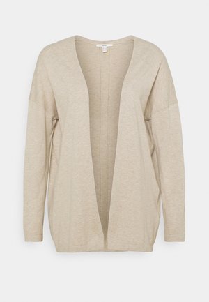 Beige avointa etuosaa oleva villatakki, joka on valmistettu pehmeästä, kevyestä kankaasta. Takissa on pitkät hihat, löysä malli ja minimaalinen ommistus yksityiskohtana keskiosassa.