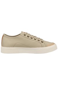 Beige canvas sneakers with a textured white rubber sole, round toe, and brown accents at the heel. Functional lacing system for secure fit.