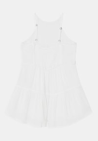White sleeveless dress with a fitted bodice, pleated texture, and flared skirt. Features adjustable straps and metal hardware accents.