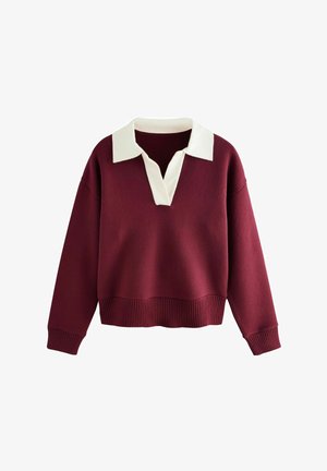 Burgundia värvi pusakas, millel on valge kraega V-kaelus, soonikkraed ja -mansetid ning pehme tekstuur. Mugav ja lohakas lõige, mis tagab mugava kandmise.