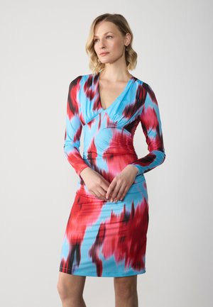 Long-sleeve dress with a V-neck, featuring a multicolor pattern of red, black, and blue. Made of smooth, stretchy fabric. Fitted silhouette.