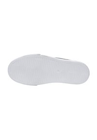 White rubber shoe sole with textured surface; features horizontal grooves and circular grip patterns for traction.