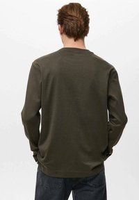 Donkergroen olijfgroen shirt met lange mouwen en een afgeronde halslijn, gemaakt van zachte stof met een minimalistisch ontwerp, gezien vanaf de achterkant. Geen zichtbare patronen of accenten.