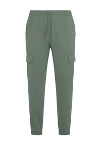 Zelené bavlnené nohavice s elastickým pásom, nastaviteľnou šnúrkou a dvoma cargo vreckami po stranách. Hladká textúra, zúžený strih.