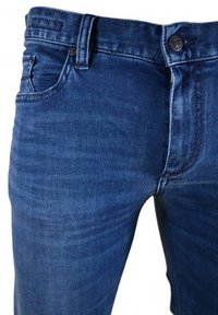 Dark blue denim jeans with a slim fit, featuring front pockets, a button closure, and subtle fading. Smooth texture with stitching details.