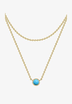 Arany színű dupla láncú nyaklánc, kerek türkizkő medállal, kör alakú keretben. Simább textúra, minimális dizájn.