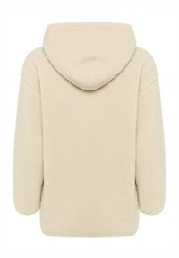 Kremowa bluza z polarowego materiału o fakturowej powierzchni, w oversize'owym kroju, z miękkim kapturem. Projekt charakteryzuje się opadającymi ramionami i zaokrąglonym dołem.