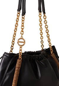 Black leather handbag with a gathered top, gold chain straps, and textured brown accents. Features a gold hardware detail.