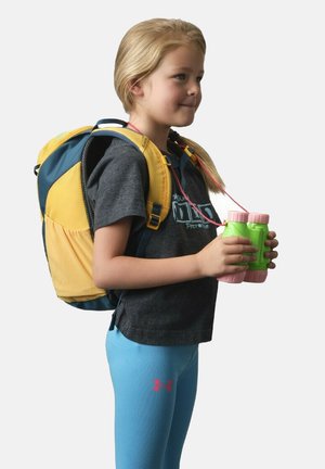 Small backpack in yellow and blue fabric, with mesh panels; girl in gray shirt and blue leggings, holding green binoculars.