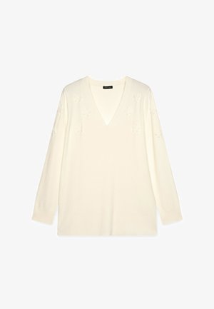 Cremefarbener V-Ausschnitt-Pullover mit langen Ärmeln. Mit strukturierten Blumenmustern auf der Vorderseite, aus einem weichen Strickmaterial gefertigt.