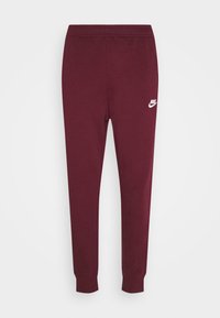 Vinröda sweatpants i bomullsblandning med elastisk midjeband och muddar, med en vit Nike-logotyp på vänster lår.