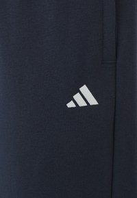 adidas Sportswear ESSENTIALS SMALL LOGO FEEL COZY OPEN HEM PANT INCLUSIVE - Calças de fato de treino - legend ink/white