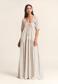 Maxi-jurk van lichtgewicht stof met een diepe halslijn, pofmouwen en verticale strepen in beige en blauw met gouden accenten.