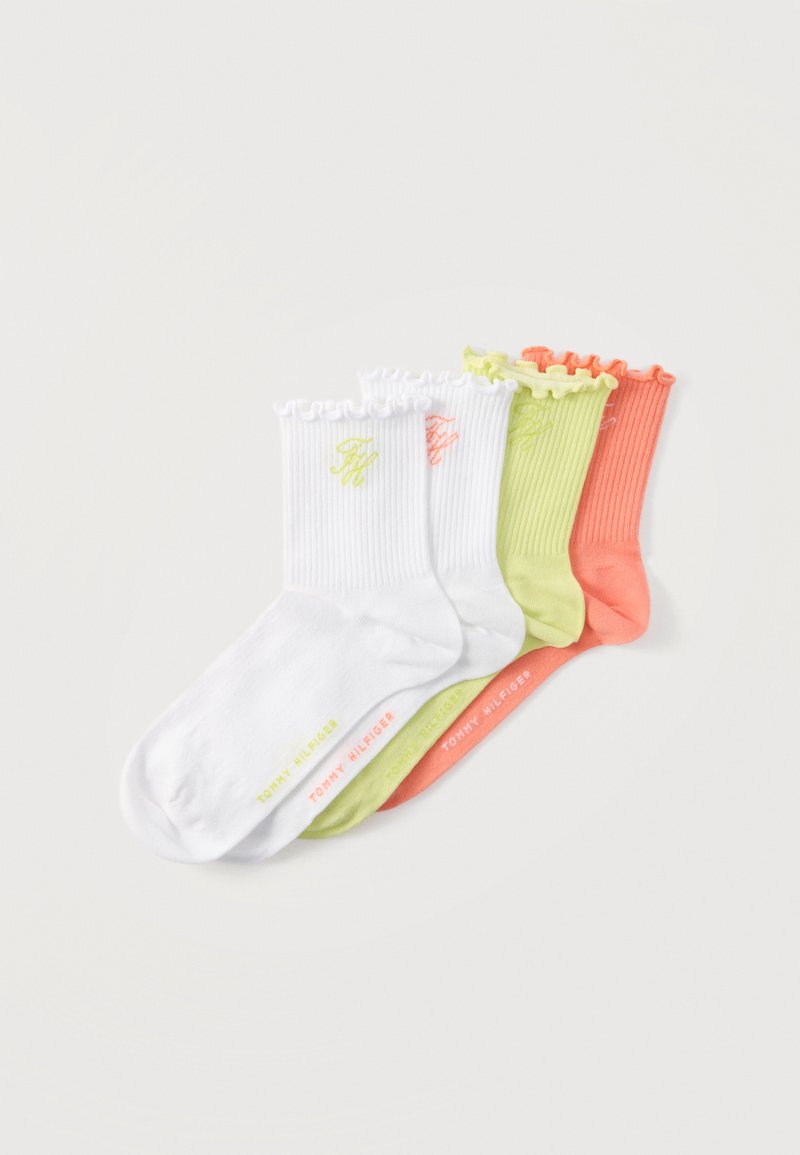 Quatre paires de chaussettes courtes côtelées avec bordures volantées en blanc, vert citron et corail, disposées en chevauchement avec un discret logo Tommy Hilfiger.