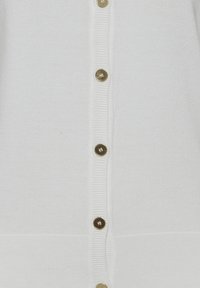 Hvid strikket cardigan med ribbet tekstur, der har seks guldfarvede knapper ned ad forsiden og en lige kant.