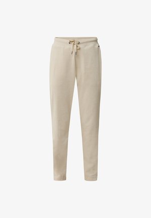 Pantalones de chándal beige en diseño ajustado, con una cintura elástica y cordón, textura suave y bolsillos laterales.