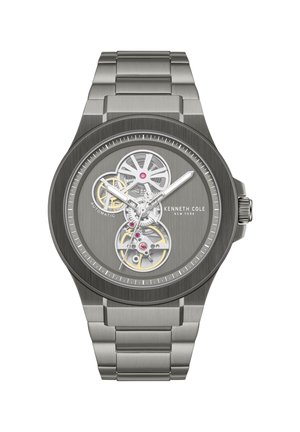 Orologio automatico in acciaio inox argento con ingranaggi a vista, tre lancette e marchio Kenneth Cole New York sul quadrante spazzolato.
