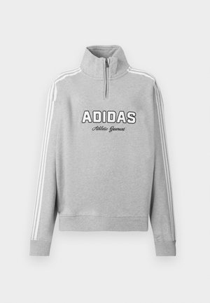 Hallide Adidas neljandik-suuruses sviiter kõrge kraega, valge kolme triibuga varrukatel ja "Adidas Athletic Garment" tekst ees.
