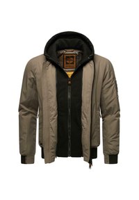 Giacca khaki con un sottogiacca in fleece nero e cappuccio. Presenta una chiusura frontale con zip, tasche laterali e polsini a costine.