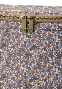 Kangaskassi, jossa on kukkakuosi vaaleanbeigeillä sävyillä, esittäen violetteja ja ruskeita kukkia. Messinkivetoketju kahdella vetoketjulla, kestävä tekstuuri.