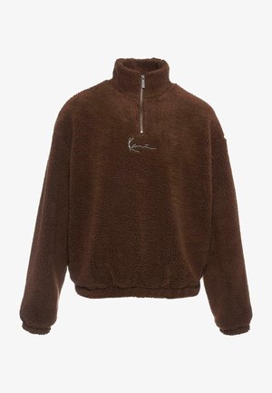 Brown fleece pullover with a high collar, half-zip front, and long sleeves. Features a white logo on the chest. Soft, textured fabric.