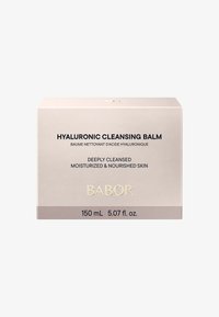 Scatola di balsamo detergente all'acido ialuronico, beige chiaro con finitura opaca. Presenta un testo nero in grassetto e accenti dorati. Dimensione indicata di 150 mL.